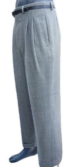 Sage green pleated pants worn by a person .