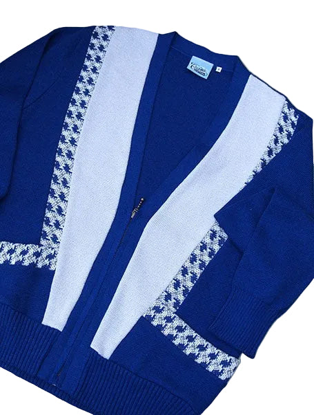 Blue and white cardigan with houndstooth pattern on a beige surface