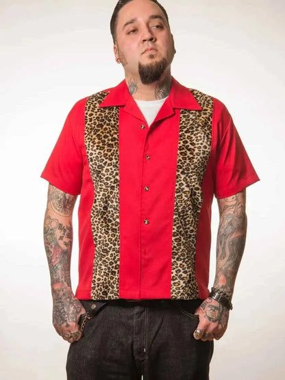 Man wearing a red shirt with leopard print panels on a white background