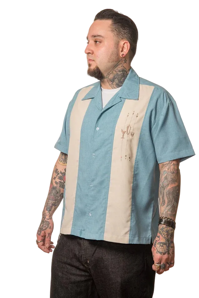 Man wearing a blue and beige striped shirt with tattoos on arms and neck against a white background
