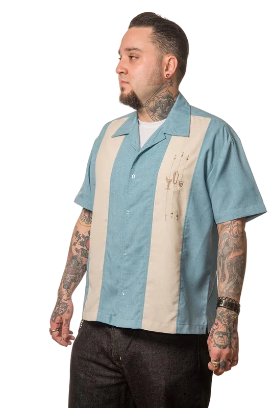 Man wearing a blue and beige striped shirt with tattoos on arms and neck against a white background