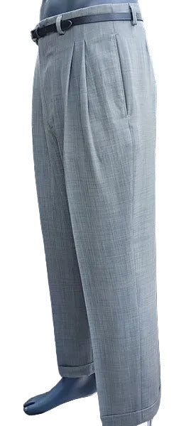 Sage green pleated pants worn by a person .